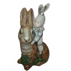 Vintage Figurine of Child in Bunny Costume Riding a Large Rabbit